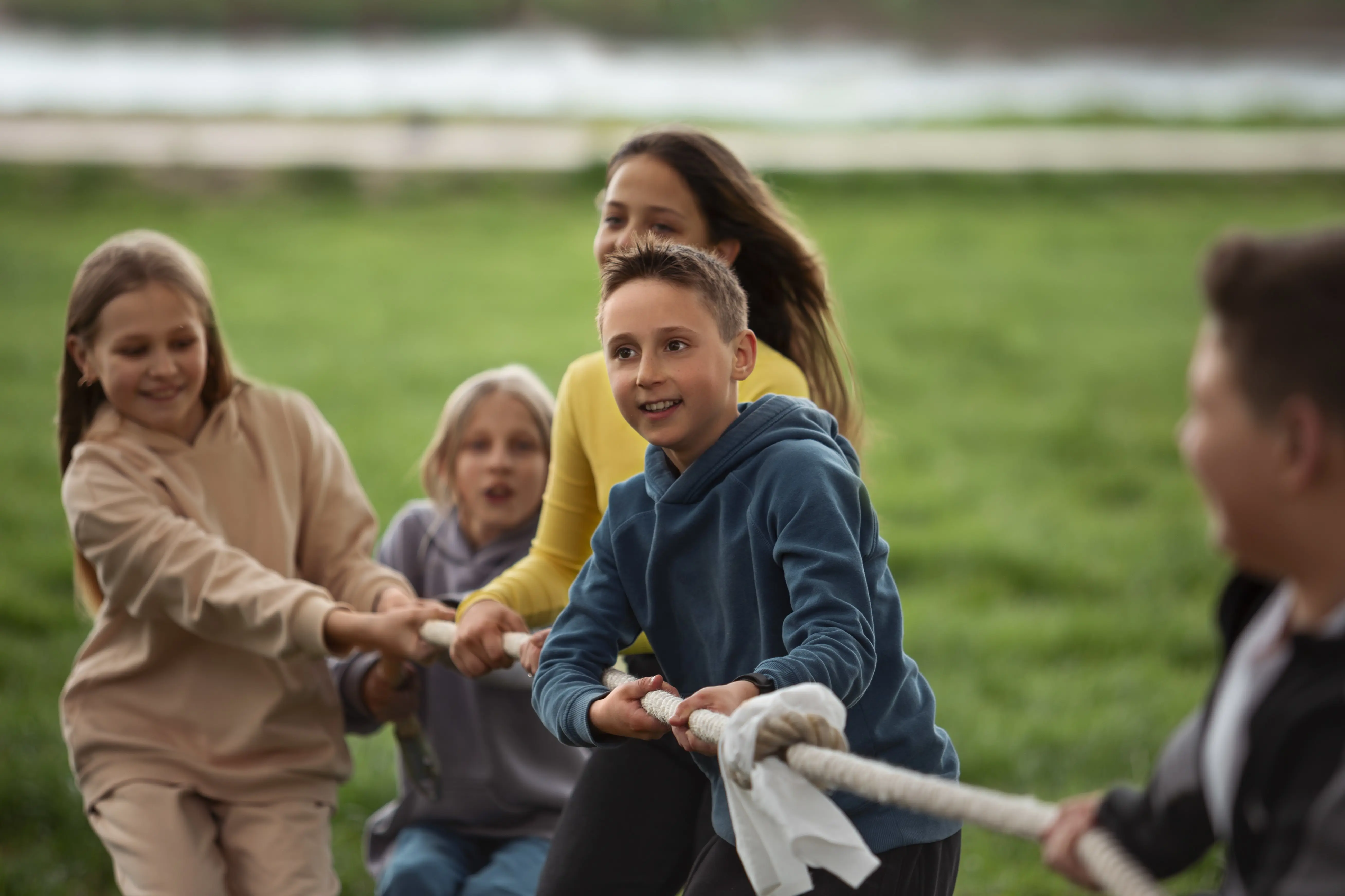 Kids playing tug of war in the park